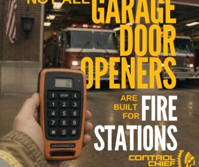 Control Chief Access 1000 industrial remote control in front of a fire station with multiple apparatus bays and fire trucks ready for emergency response.